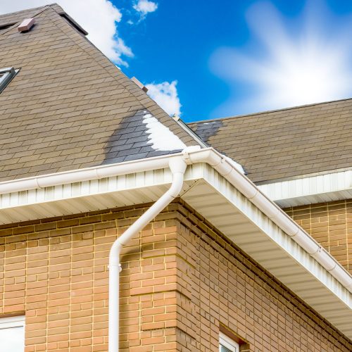 chimney on the roof of the house against the blue sky